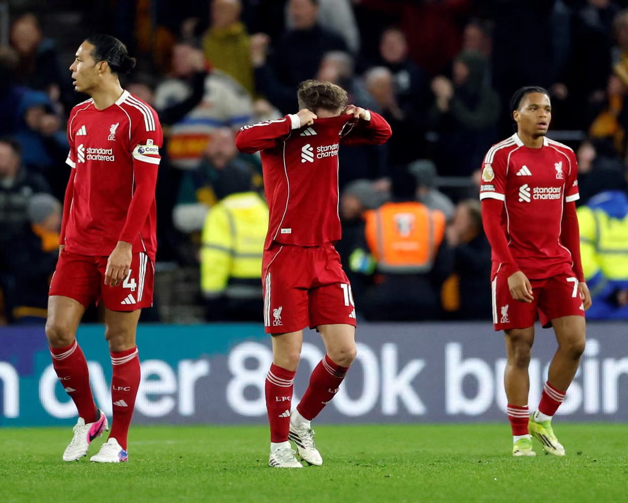 Liverpool players react to conceding a goal.
